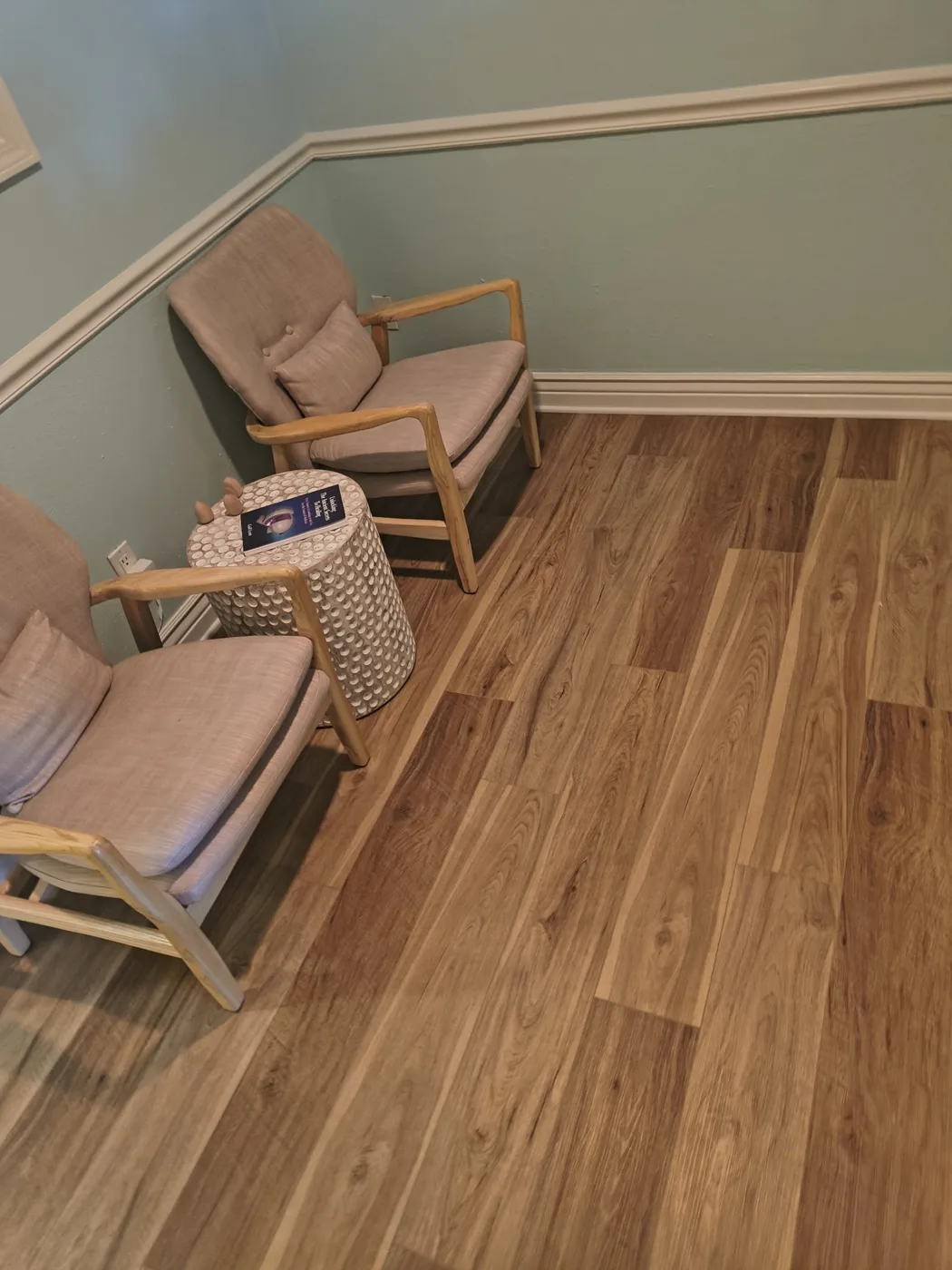Seating nook against the wood-plank accent wall at WAVE in Sarasota